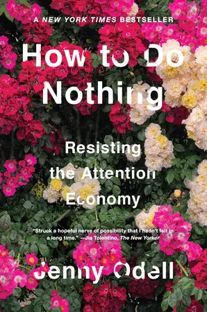 How to Do Nothing book cover - title in white text on dark green foliage and pink and white clustered flowers. The tagline reads 'Resisting the Attention Economy'.